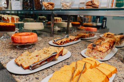 a buffet with plates of food on a counter at Pousada Capital das Águas in Maceió