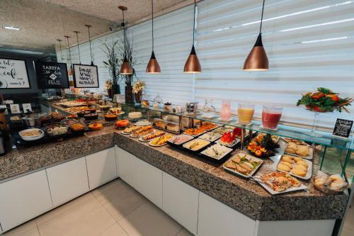 a buffet line with many different types of food at Pousada Capital das Águas in Maceió