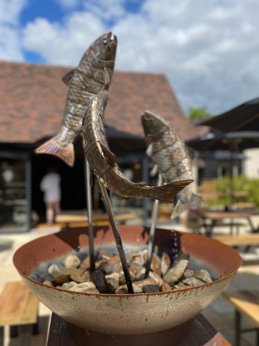 a bowl with three fish sculptures in it at The Duke on The Test in Romsey