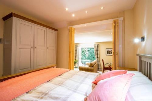 a bedroom with a large bed with an orange blanket at Riverside in Knaresborough
