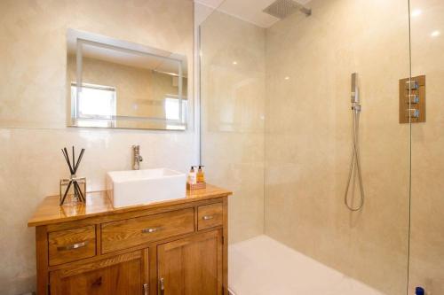 a bathroom with a sink and a shower at Riverside in Knaresborough