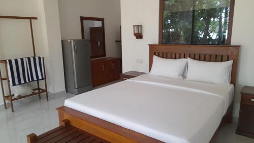 Postel nebo postele na pokoji v ubytování Oruwa Turtle Beach Villa