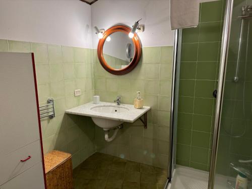 a bathroom with a sink and a mirror at Villa Rama in Aci Castello
