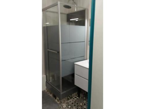 a bathroom with a glass cabinet and a sink at Appartement 6 personnes in Saint-François-Longchamp