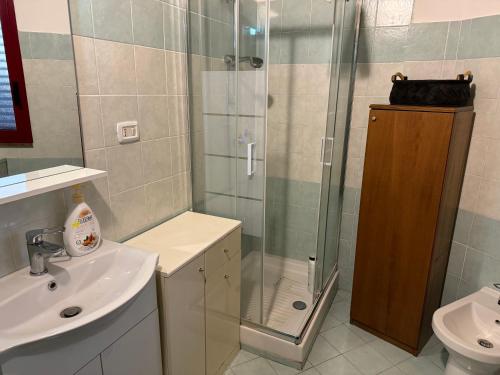a bathroom with a shower and a sink at Villa Rama in Aci Castello
