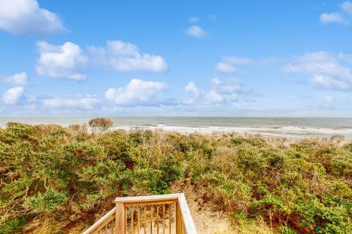 a wooden staircase leading to a beach with the ocean at Sea Star #44-B in Buxton