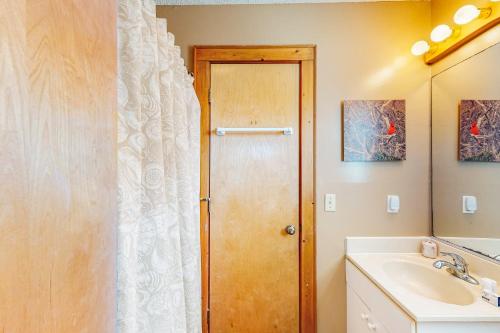 a bathroom with a shower curtain and a sink at Sea Star #44-B in Buxton