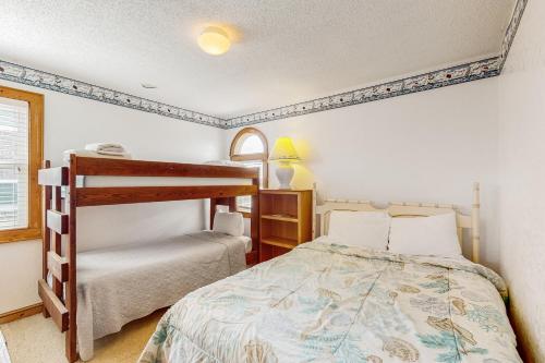 a bedroom with a bed and a bunk bed at Sea Star #44-B in Buxton