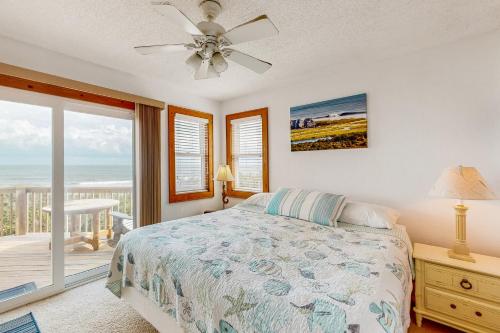 a bedroom with a bed and a view of the ocean at Sea Star #44-B in Buxton