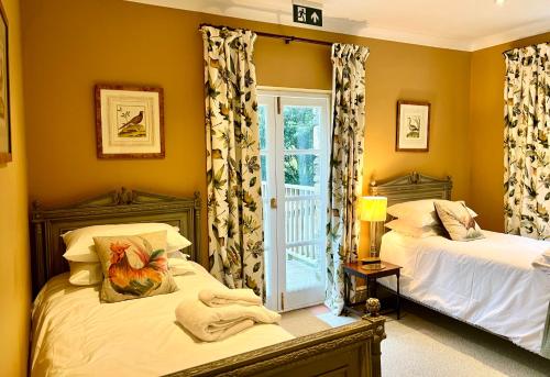 a bedroom with two beds and a window at The Mill House in Santon