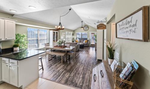 a kitchen and living room with a table and a dining room at 2BR Condo - Near SDC - 2 Pools - Golf Onsite - FREE TICKETS INCLUDED - SB 9-5 in Branson