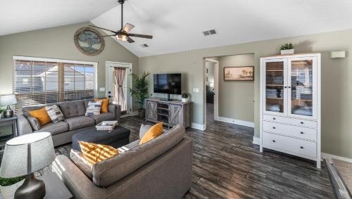a living room with a couch and a tv at 2BR Condo - Near SDC - 2 Pools - Golf Onsite - FREE TICKETS INCLUDED - SB 9-5 in Branson