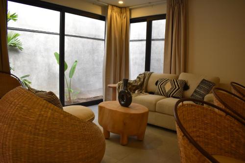 a living room with a couch and chairs and a table at Punta Agave Suites in Oaxaca City