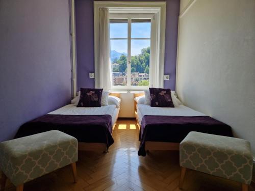 a room with two beds and a window at Boutique Hotel KARL in Luzern