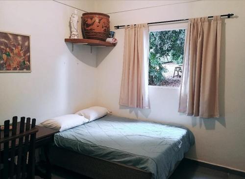 Giường trong phòng chung tại Chácara Tipuana