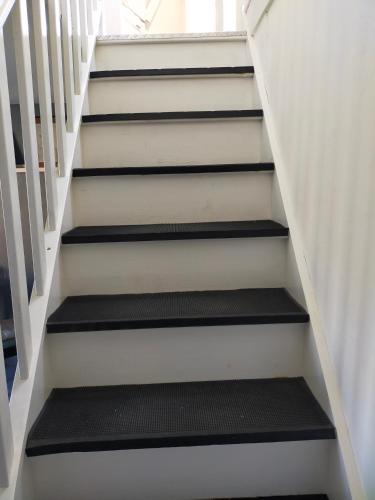 a stairwell with black treads in a house at Gîte Se Sentir Libre in Crozant