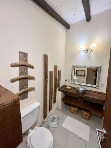 a bathroom with a sink and a toilet and a mirror at Momocho in Esquina