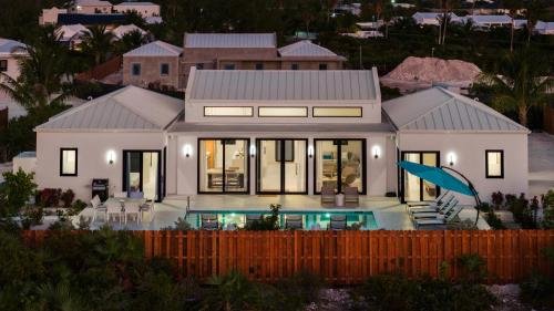 a large white house with a swimming pool at Upper East Side Enclave #14 in Long Bay Hills