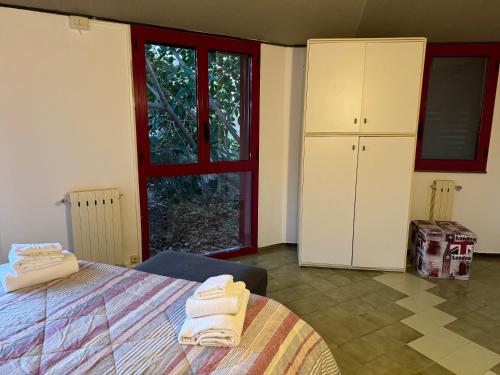 a bedroom with a bed with towels on it at Villa Rama in Aci Castello