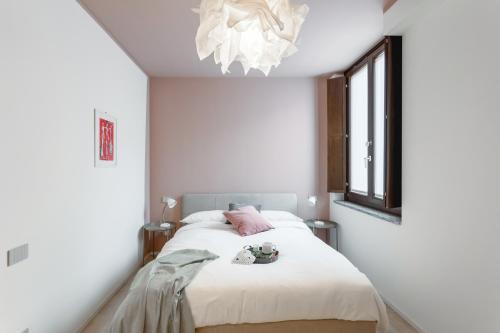 a bedroom with a bed and a window at Varesina Suite - Pavia City Center - by Host4U in Pavia