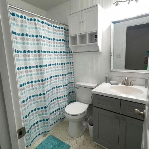 ein Badezimmer mit Toilette und Duschvorhang in der Unterkunft Deodara Cottage in Augusta