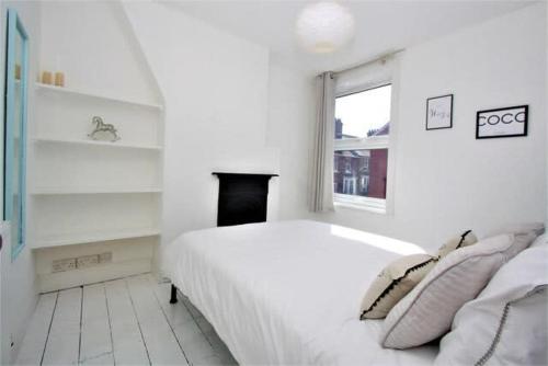 Kama o mga kama sa kuwarto sa Cosy 2 bedroom Victorian townhouse in the town Centre