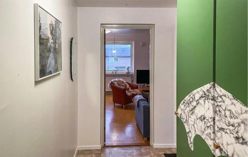 a hallway with a living room with green walls at Lovely Apartment In Hyltebruk With Wifi in Hyltebruk