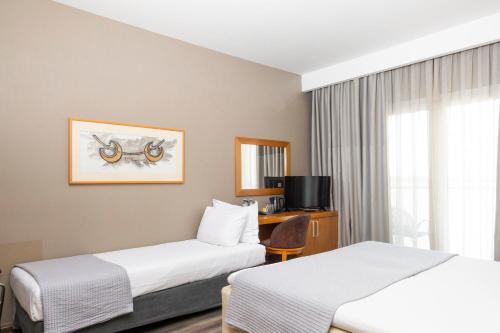 a hotel room with two beds and a window at Golden Star City Resort in Perea