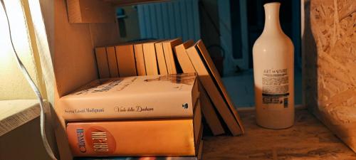 a couple of boxes sitting next to a bottle of wine at Residenza BiblioSosta in Ventimiglia