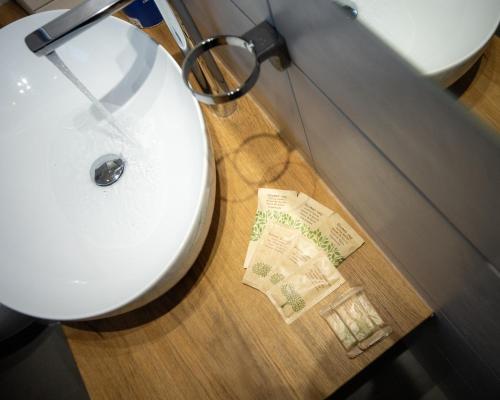 a bathroom with a toilet with a ticket on the floor at Hotel Leon D'Oro in Alfedena