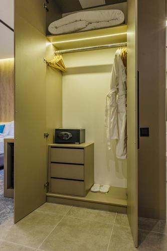 a room with a closet with a dresser and a bed at ТАУ-HOUSE in Kok-Shoky