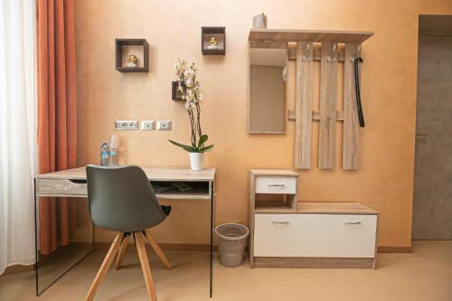 escritorio con silla y espejo en la habitación en Affittacamere Gioiello, en Génova