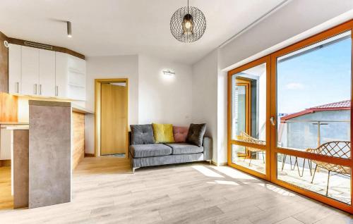 a living room with a couch and a large window at 2 Bedroom Gorgeous Apartment In Hel in Hel