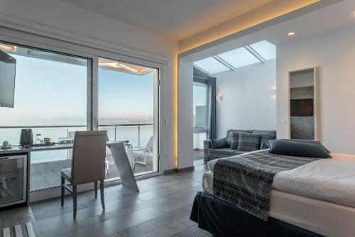 a bedroom with a bed and a view of the ocean at Golden Star City Resort in Perea