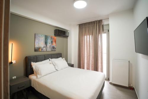 Ένα ή περισσότερα κρεβάτια σε δωμάτιο στο Euphoria Apartments