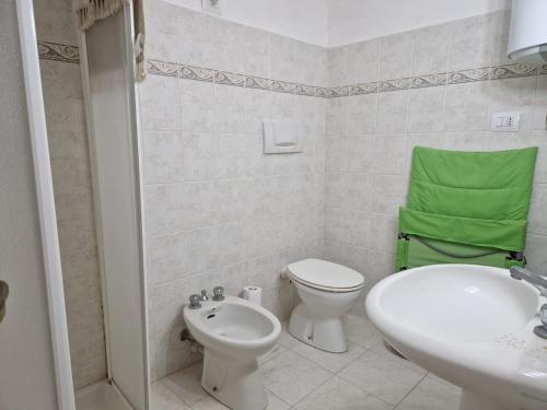 Casa Marciana 1 - Isola D'Elba في مارشيانا: حمام ابيض مع مرحاض ومغسلة