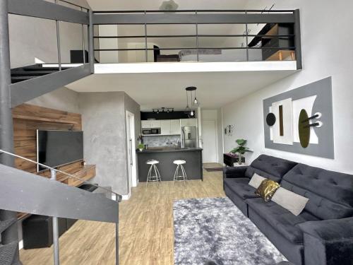 a living room with a couch and a loft at Saint Sebastian Flat 704 - Com Hidro! até 4 pessoas, Duplex, no centro in Jaraguá do Sul