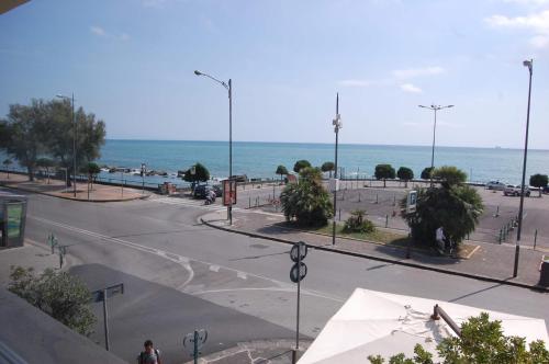 an empty street with the ocean in the background at La Madegra Seasuite in Salerno