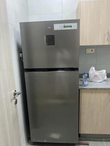 a stainless steel refrigerator in a kitchen at City Focus ابراج المهلب in Muscat