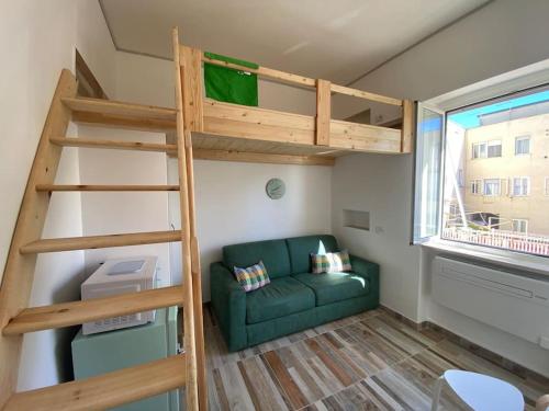 a living room with a bunk bed and a couch at Nido sul mare! in Torvaianica