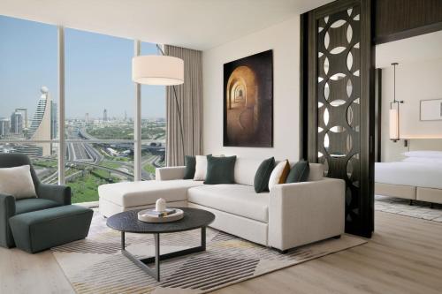 a living room with a couch and a table at Sheraton Grand Hotel, Dubai in Dubai