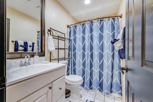 a bathroom with a blue shower curtain and a toilet at Modesto Vacation Home 6 Mi to Downtown! in Modesto