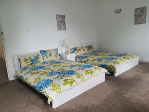 two beds in a white room with at Monarch House in Manchester