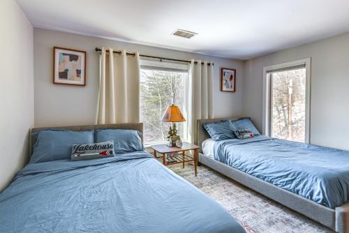 a bedroom with two beds and a window at Quiet Mountain-View Home Near Conway and Hiking in Fryeburg
