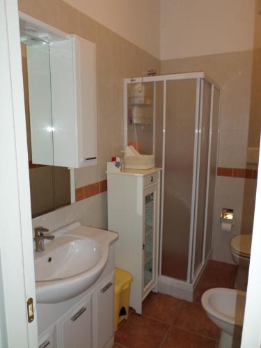 a bathroom with a sink and a shower and a toilet at Le Anfore di Arpi in Foggia