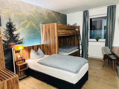 a bedroom with two bunk beds in a room at AUSZEIT DAS HOTEL Asbach-Bäumenheim in Asbach-Bäumenheim
