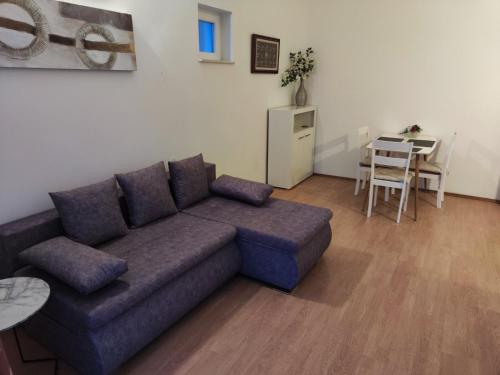 a living room with a couch and a table at Appartment Ksenija 3 in Mali Lošinj