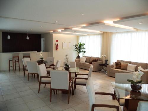 a living room with a table and chairs and a couch at Vista Rio - A vista é Incrível in Manaus
