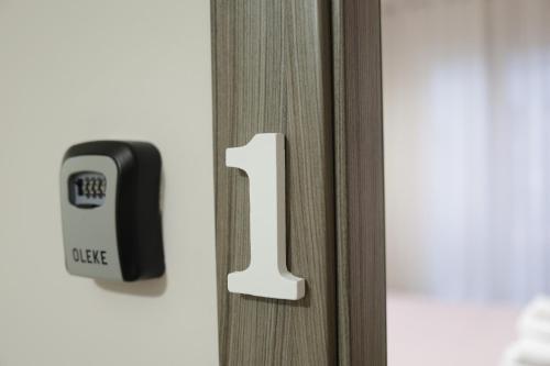 a lock on a door with the number one on it at Casa di Paola in Palermo