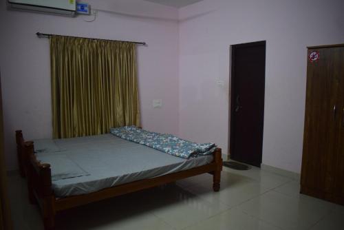 a small bed in a room with a window at DELTA HOSPITALITY - sea faceing rooms with private beach in Kalyānpur
